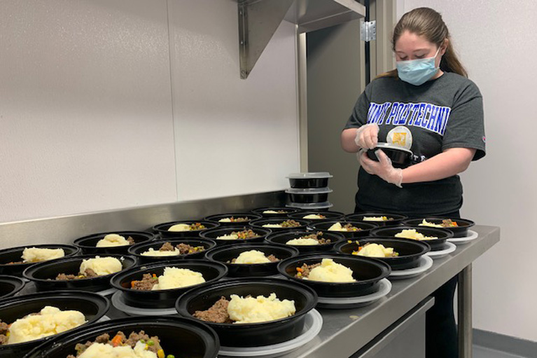 Young lady helping prepare meals