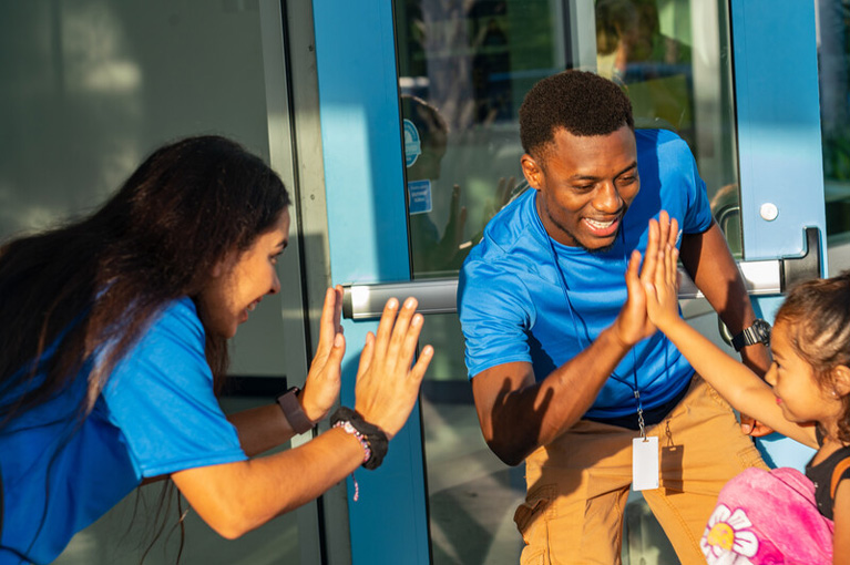 YDP high-fiving a Club kid