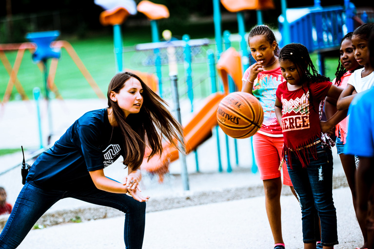 Youth Development Professional and Club kids playing basketball
