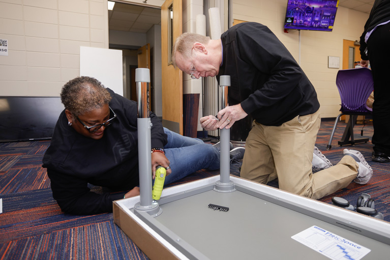 Boys & Girls Clubs of America President and CEO Jim Clark and Executive Vice President and Chief Operations Officer Lorraine Orr working on table assembly.