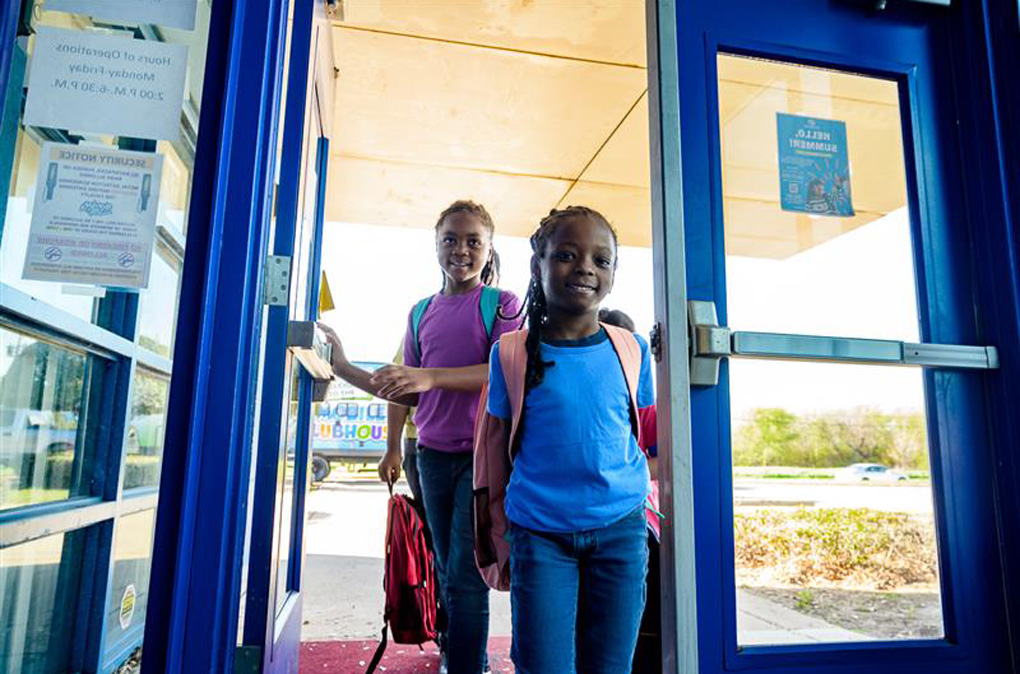 Two Club kids entering Club front door