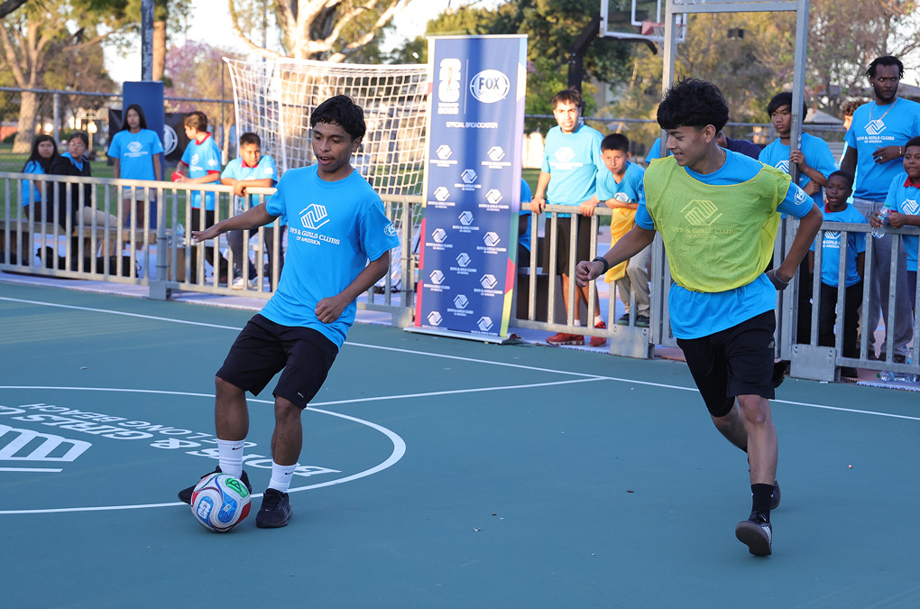 Club kids and teens playing soccer